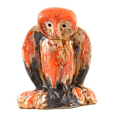 Lot 4 - Eric Leaper, a large pottery model of an owl on a branch, running burnished orange glaze over a manganese body, 25.5cm high