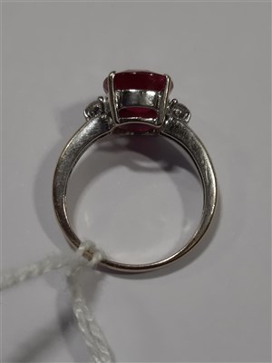 Lot 203 - A ruby and diamond three stone ring, an oval mixed cut ruby