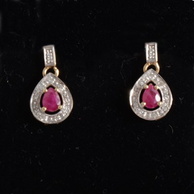 Lot 179 - A pair of ruby and diamond drop earrings.