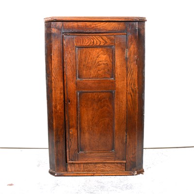 Lot 409 - George III oak hanging corner cupboard