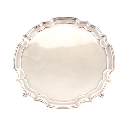 Lot 255 - A silver salver by A Chick & Sons Ltd, Birmingham 1977, moulded pie-crust edge, four scrolled feet, diameter 31cm, weight approx. 24.5oz.