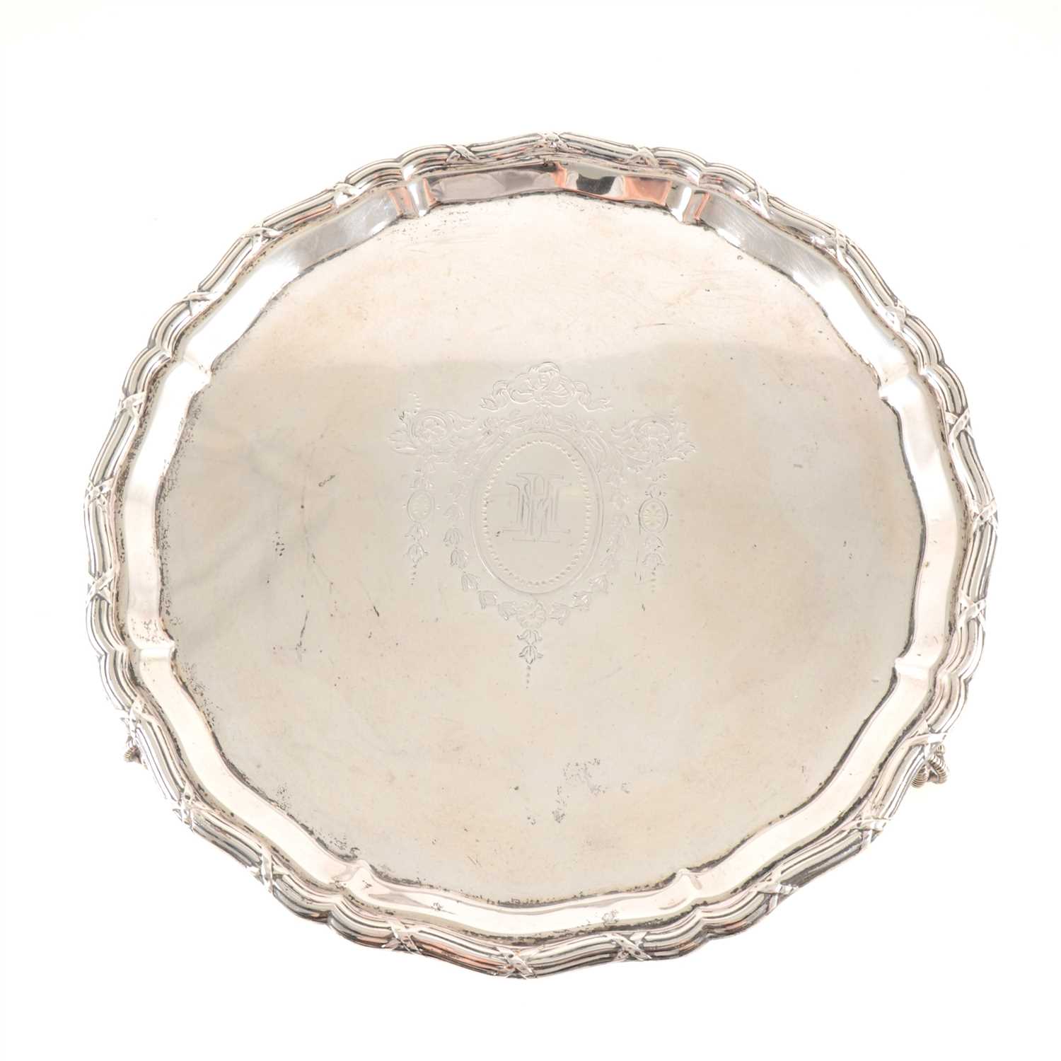 Lot 193 - A silver salver by Mappin & Webb, Sheffield 1926, moulded pie-crust and reeded edge, engraved monogram within a cartouche, raised on talon and ball feet, diameter 26cm, weight approx. 13oz.
