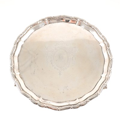 Lot 193 - A silver salver by Mappin & Webb, Sheffield 1926, moulded pie-crust and reeded edge, engraved monogram within a cartouche, raised on talon and ball feet, diameter 26cm, weight approx. 13oz.
