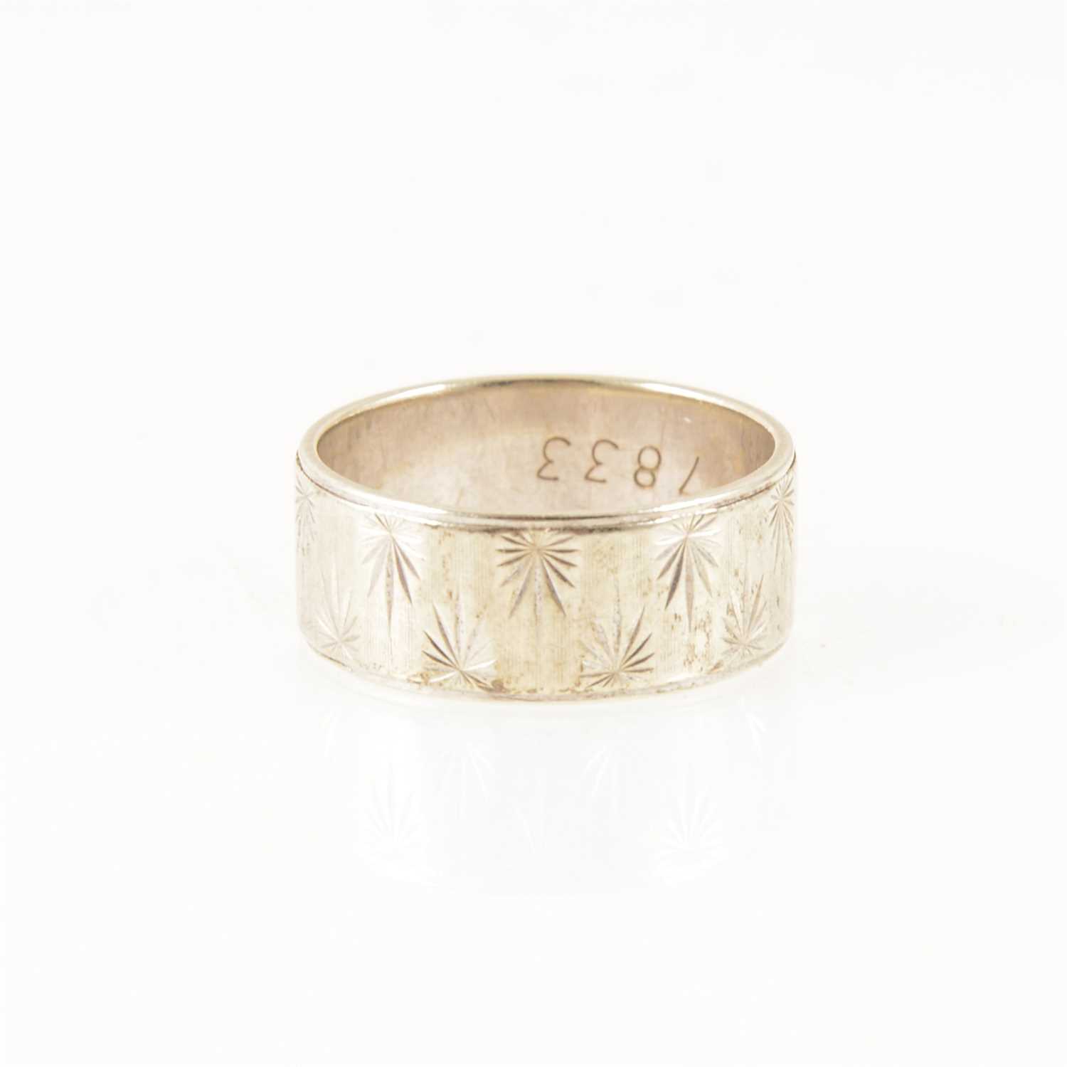 Lot 261 - A 9 carat white gold ring, shank engraved with star pattern, approximate weight 5.5g, ring size P.