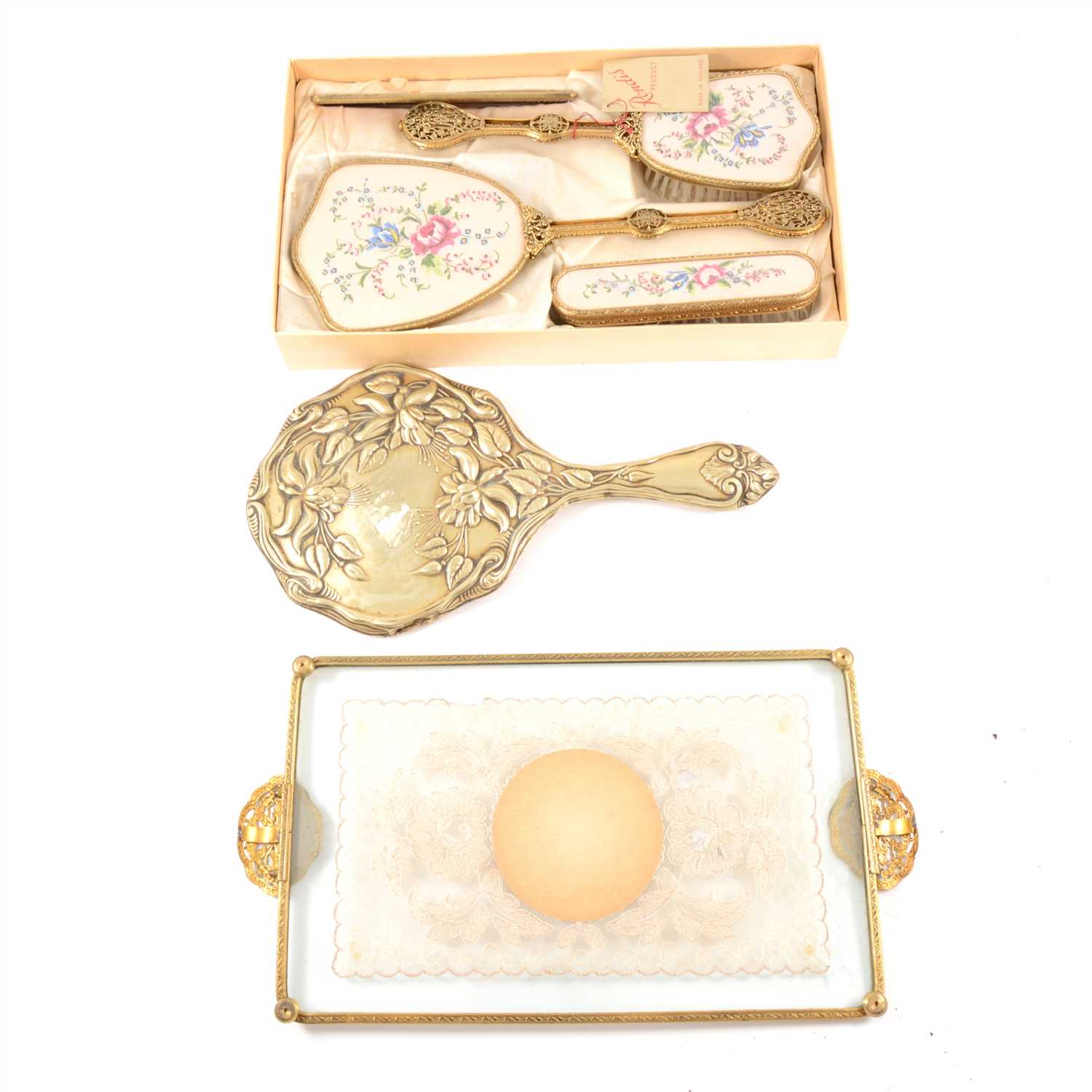 Lot 113 - A boxed dressing table set by Rondis, comprising a hair brush, hand brush, comb, mirror with floral design and filigree handles, a matching tray, a hand mirror with fuchsia design, and a tapestry