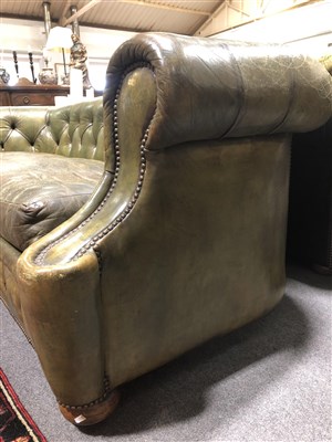 Lot 486 - Button leather Chesterfield settee, scrolled ends, 217cm.