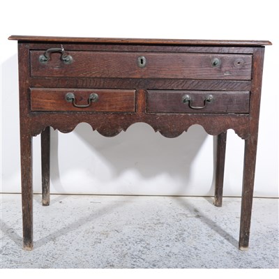 Lot 307 - A George III oak lowboy, ...