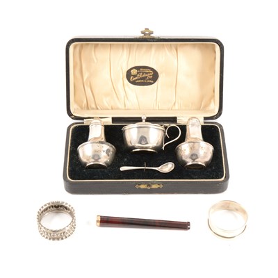 Lot 186 - A silver condiment set by Joseph Gloster Ltd, cased, Birmingham 1928, with a spoon by T H Hazelwood & Co, Birmingham 1909, two silver napkin rings, total gross weight approx. 3.9oz