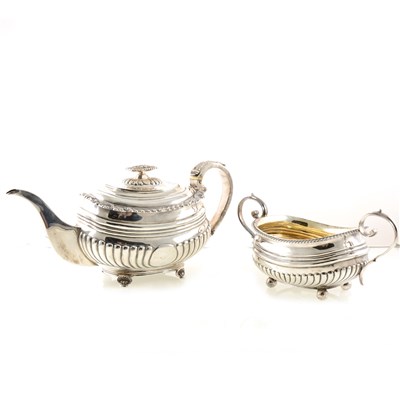 Lot 214 - A George III silver teapot by Thomas Wilkes Barker, London 1819, semi fluted, gadrooned and shell cast rim, leaf-capped reeded handle, 15cm, and a similar sugar bowl
