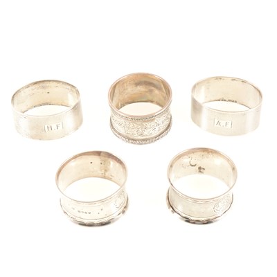 Lot 242 - A pair of silver napkin rings by Deakin & Francis, Birmingham 1938, another pair by William Evans, London 1869, and one other napkin ring, total weight approx. 3.5oz.