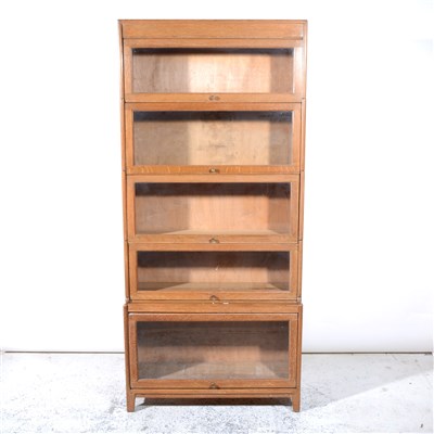Lot 341 - A light oak five height sectional bookcase