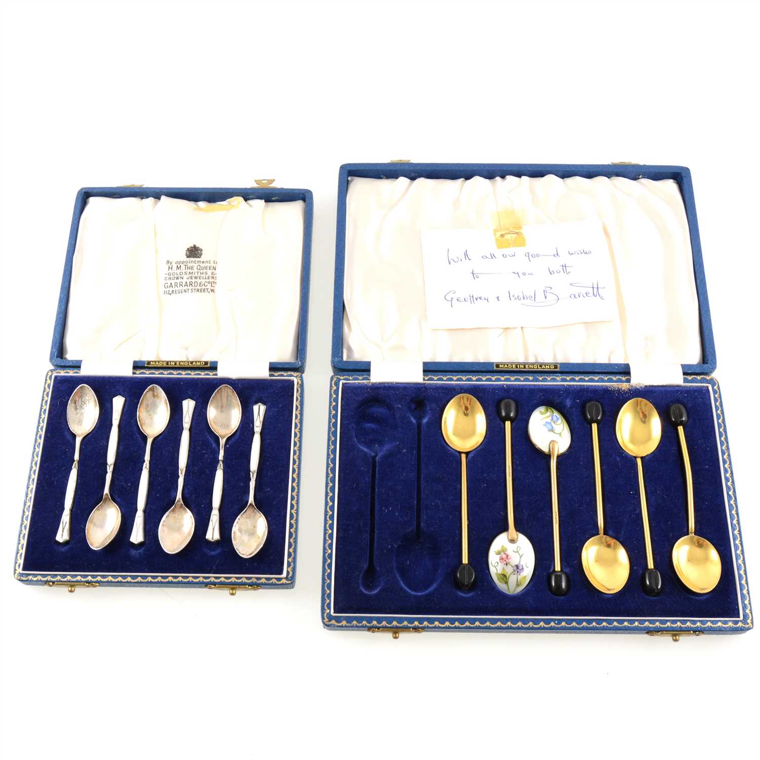 Lot 204 - A cased set of six silver and enamelled coffee spoons, Birmingham 1960, a cased set of white metal and enamelled pickle forks, marked "925S", and a part set of gilded coffee bean spoons.