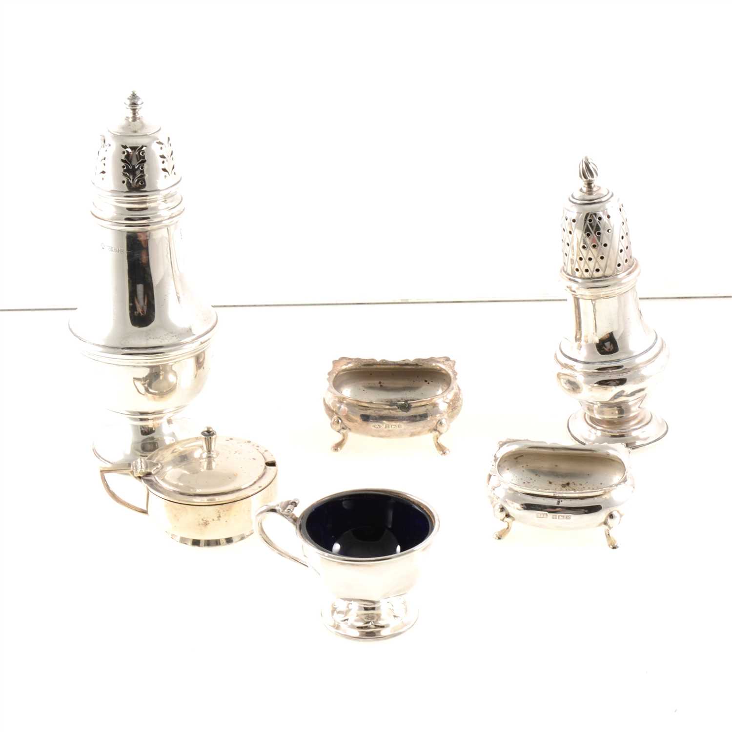 Lot 208 - A silver sugar caster by Adie Brothers Ltd, baluster shape, Birmingham 1961, 18.5cm, another by JB Chatterley & Sons Ltd, Birmingham 1961, various silver condiments (some with blue glass liners)