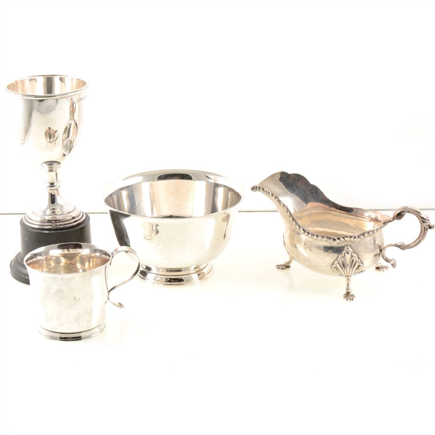 Lot 209 - A silver trophy by Pinder Brothers, engraved "Great Glenn Gymkhana 1955 1st Handy Hunter Trial", black plastic plinth, Sheffield 1950, a silver sauce boat by Barker Brothers Silver Ltd, gadroon edge