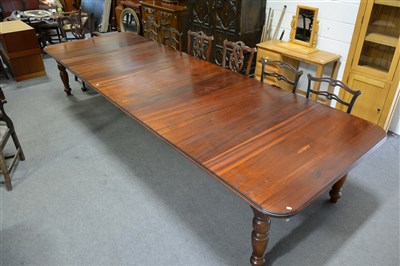 Lot 378 - A large reproduction mahogany and stained wood extended dining table