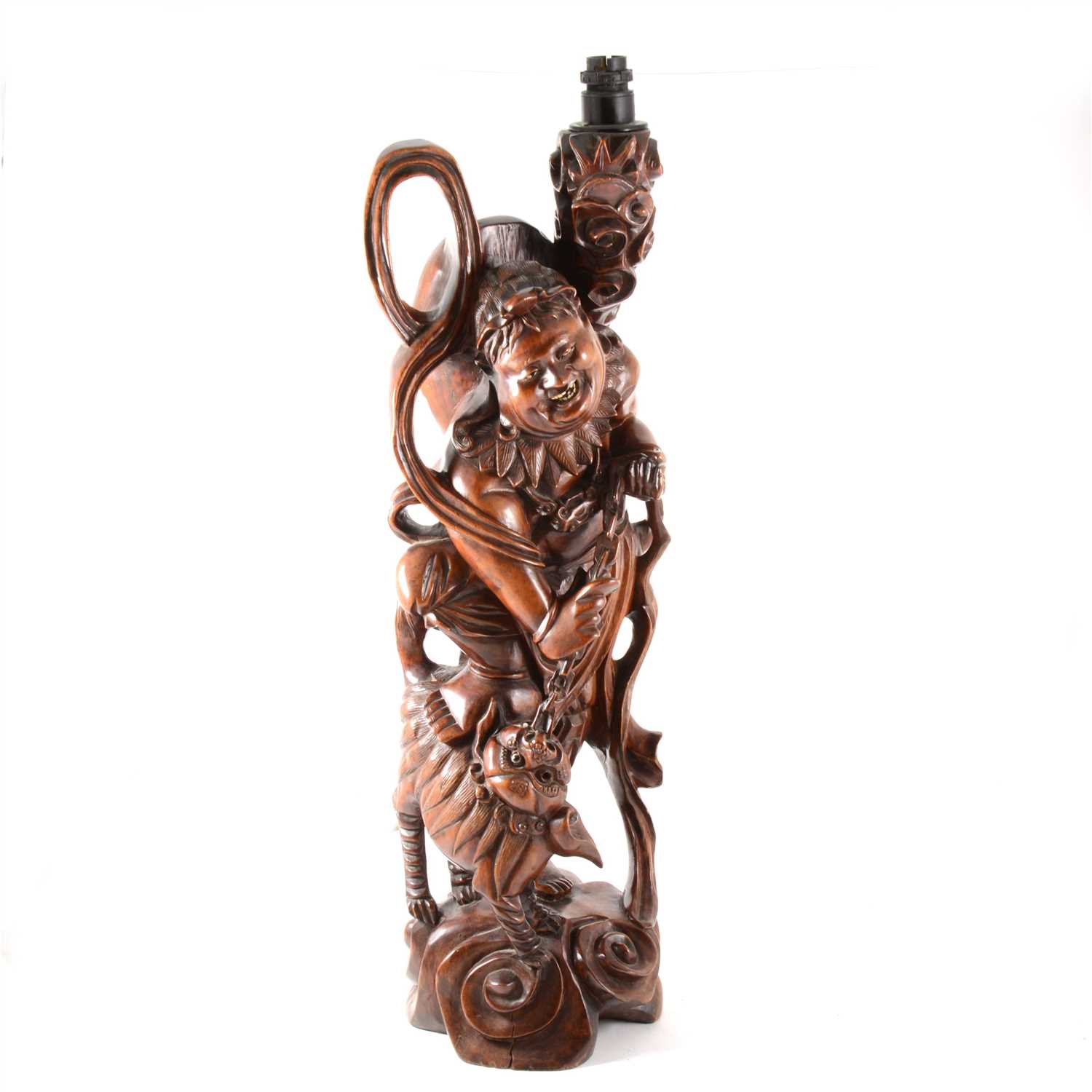 Lot 224 - Chinese carved hardwood figure of an immortal, with a Temple dog, adapted as a table lamp.