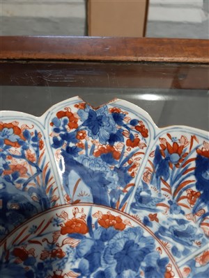 Lot 20 - Four Imari shallow bowls, lotus leaf shape, decorated in blue and iron red.