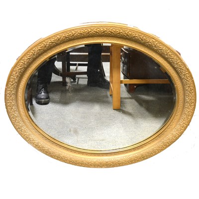 Lot 375 - An oval bevelled glass wall mirror in a gilt gesso frame