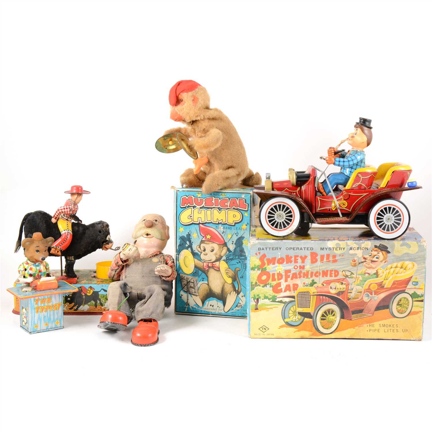 Lot 79 - Tin-plate and early battery operated toys; five including musical chimp.