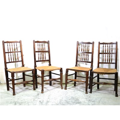 Lot 340 - A harlequin set of five ash and stained wood spindle-back dining chairs