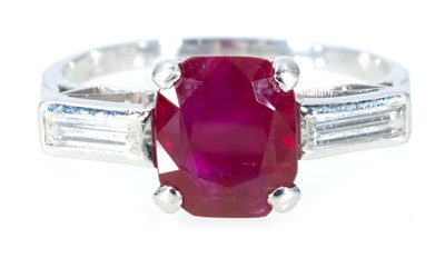 Lot 202 - A ruby and diamond three stone ring.