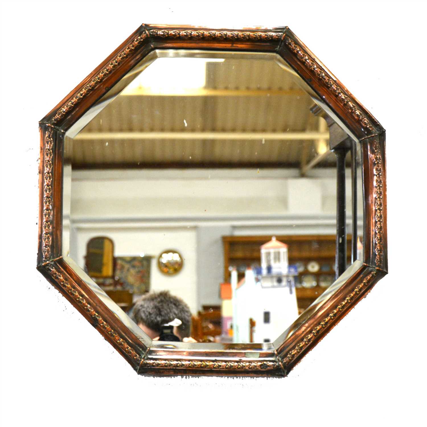 Lot 153 - An octagonal copper framed mirror.