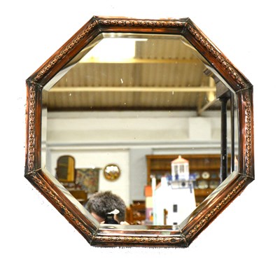 Lot 153 - An octagonal copper framed mirror.