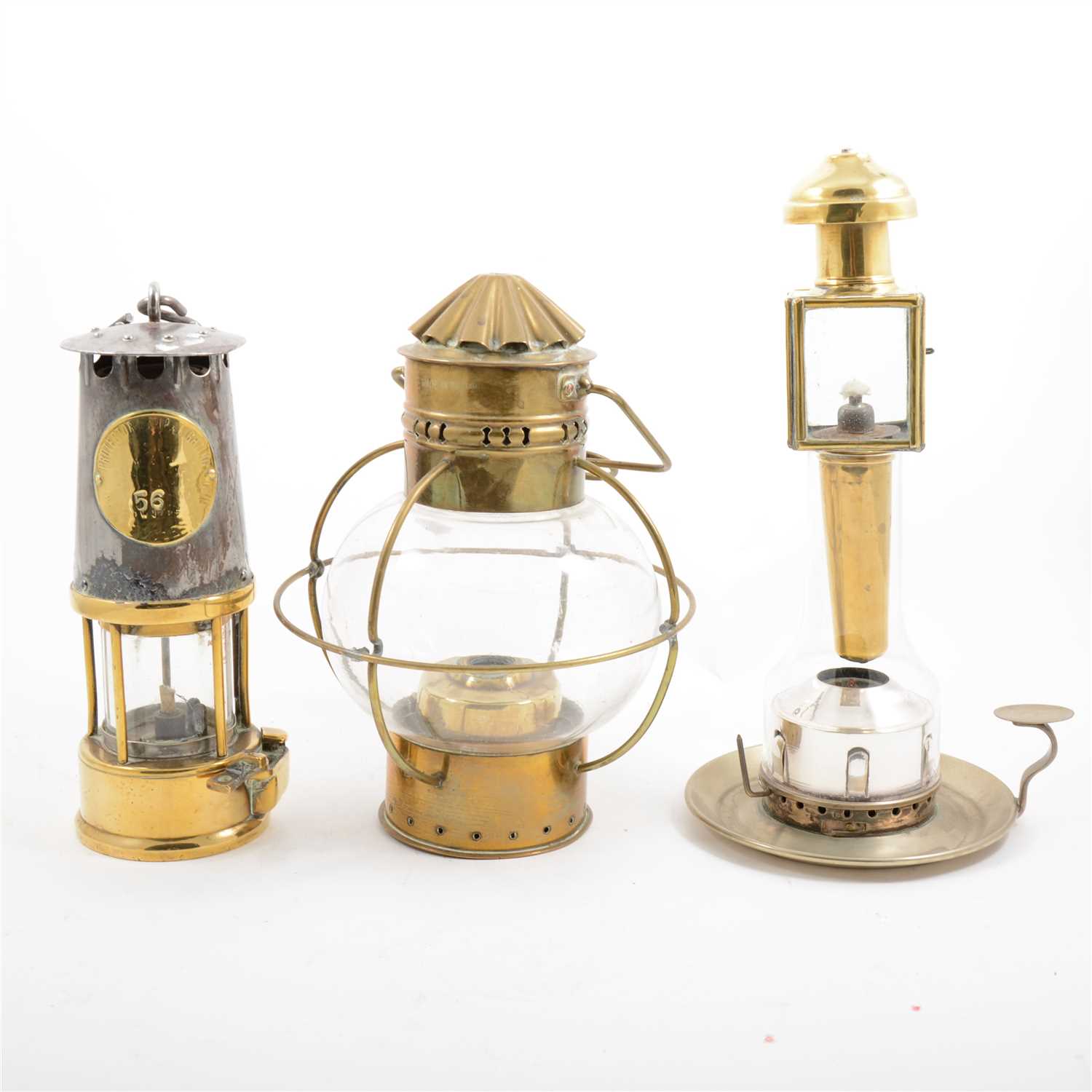 Lot 104 - A miners lamp, hanging oil lamp, Miller & Sons patent chamberstick, etc