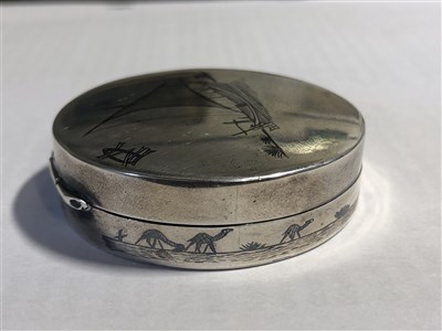 Lot 239 - A white metal patch box with mirror depicting a niello sailing junk, 50mm, and another 25mm pill box with engine turned cover, Birmingham 1918.