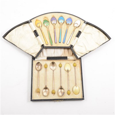 Lot 244 - A cased set of silver gilt and enamelled teaspoons by Levi & Salaman, Birmingham 1925, and a cased set of silver and enamelled coffee spoons by Henry Clifford Davis, bean finials, Birmingham 1926.