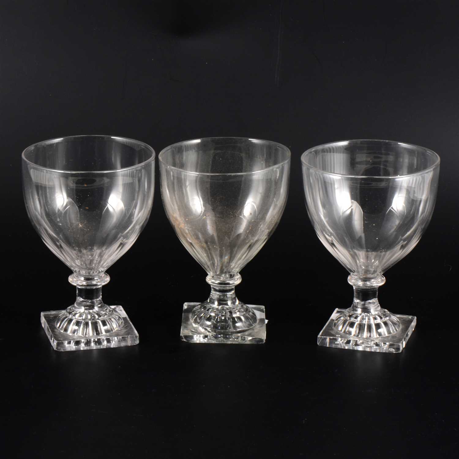 Lot 33 - Three similar George III rummers with lemon squeezer bases