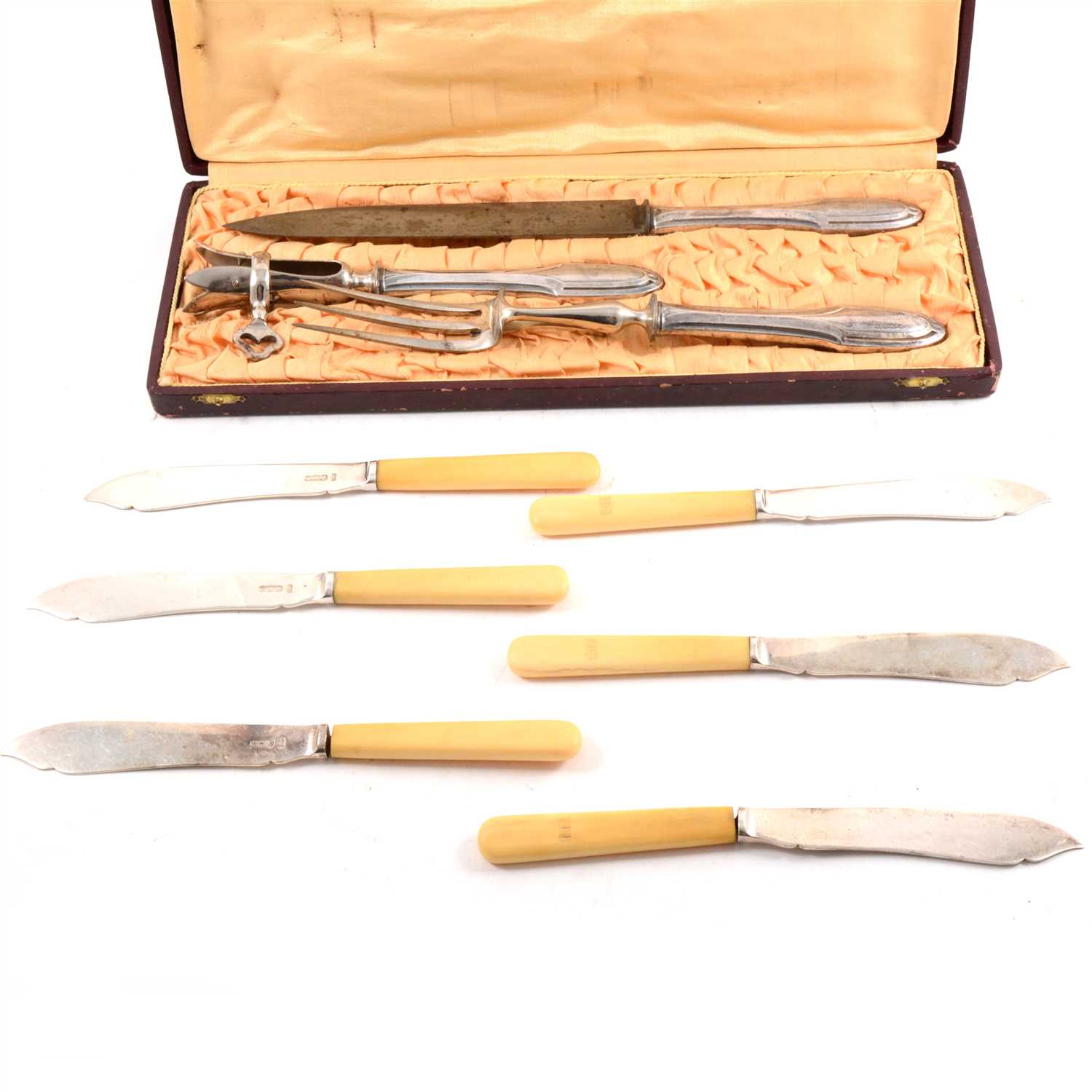 Lot 182 - A set of twelve silver fish knives and forks by Mappin & Webb Ltd, plus a cased French silver-handled three piece carving set