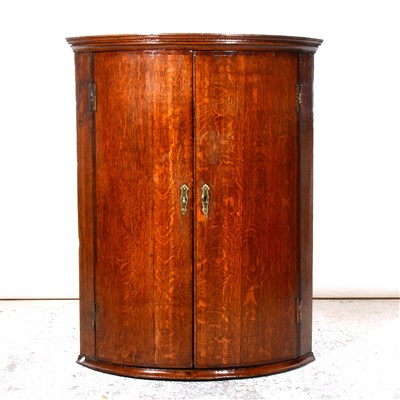 Lot 301 - George III oak bowfront hanging corner cupboard