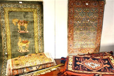 Lot 440 - Three modern silk rugs/ wall hangings, a runner, and a Persian saddle bag