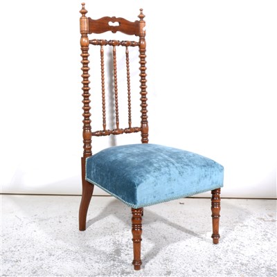 Lot 374 - A continental walnut spindle-back nursing chair