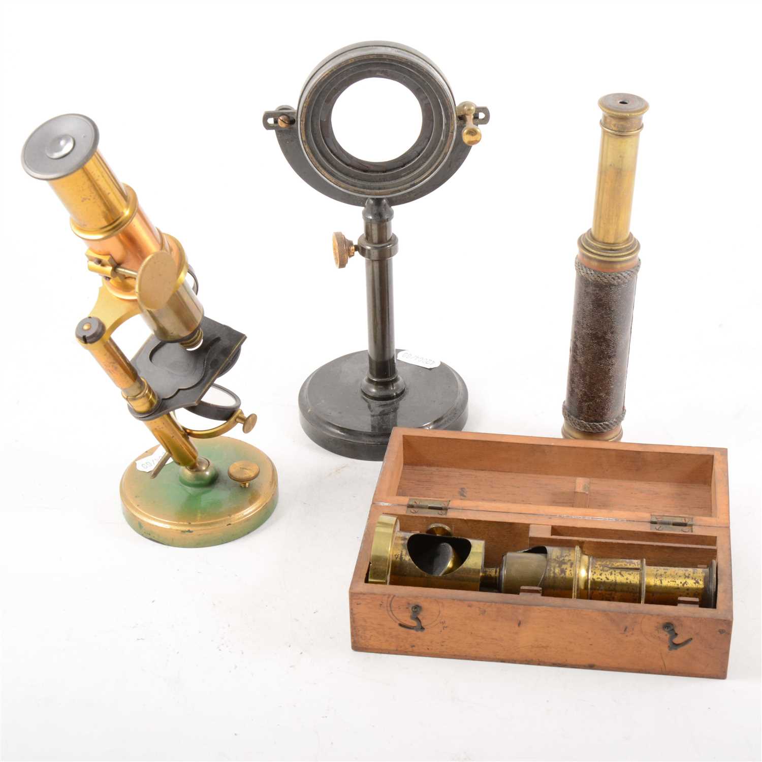 Lot 91 - A lacquered brass student microscope, field microscope, and two telescopes