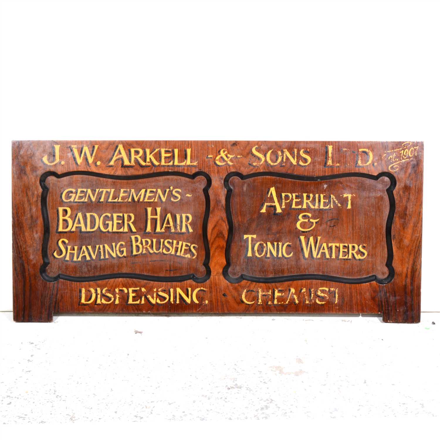 Lot 425 - A stained wood advertisement panel