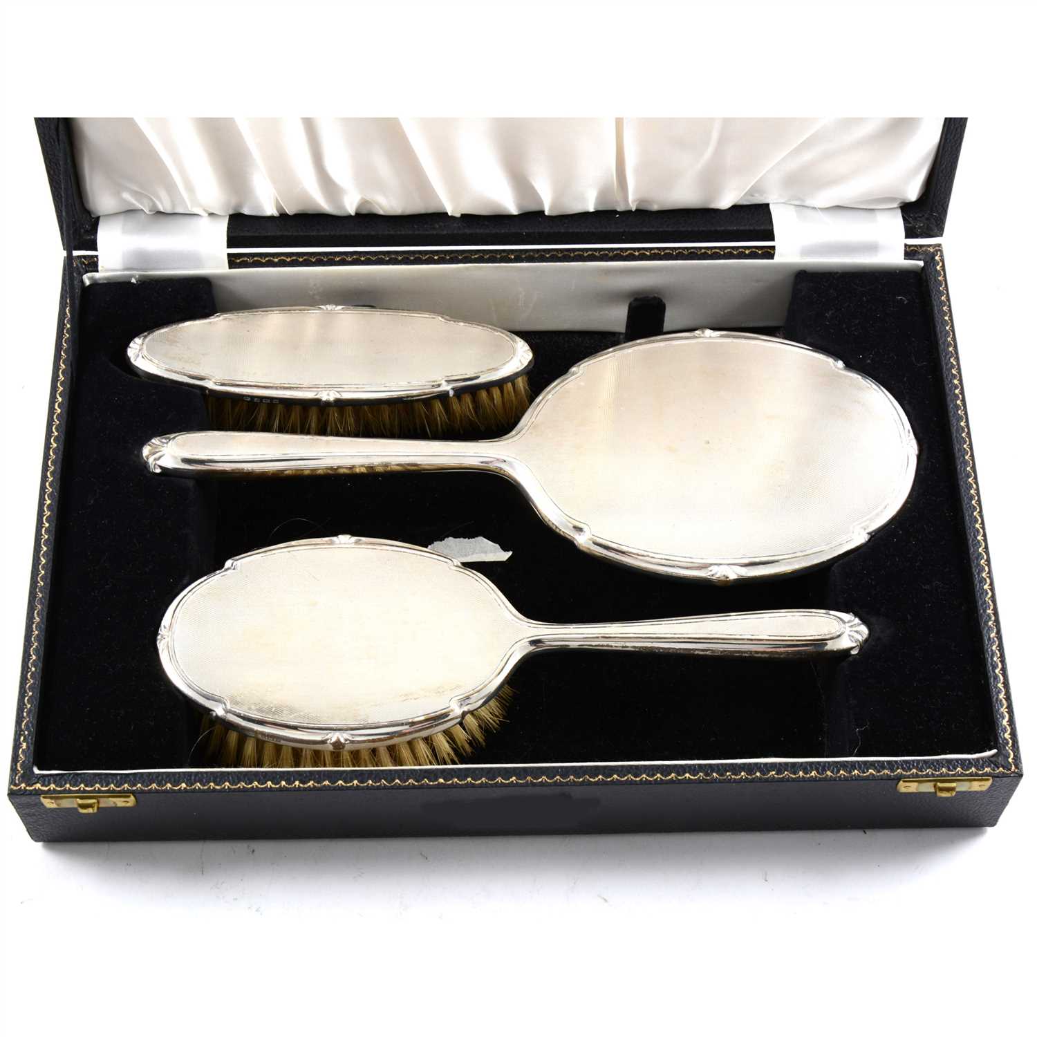 Lot 180 - A cased silver backed dressing table set
