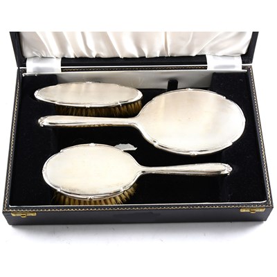 Lot 180 - A cased silver backed dressing table set