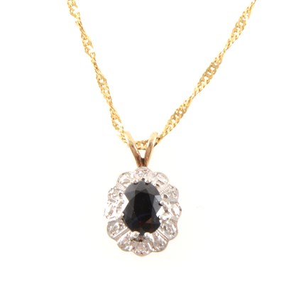 Lot 257 - A sapphire and diamond oval cluster pendant and chain.