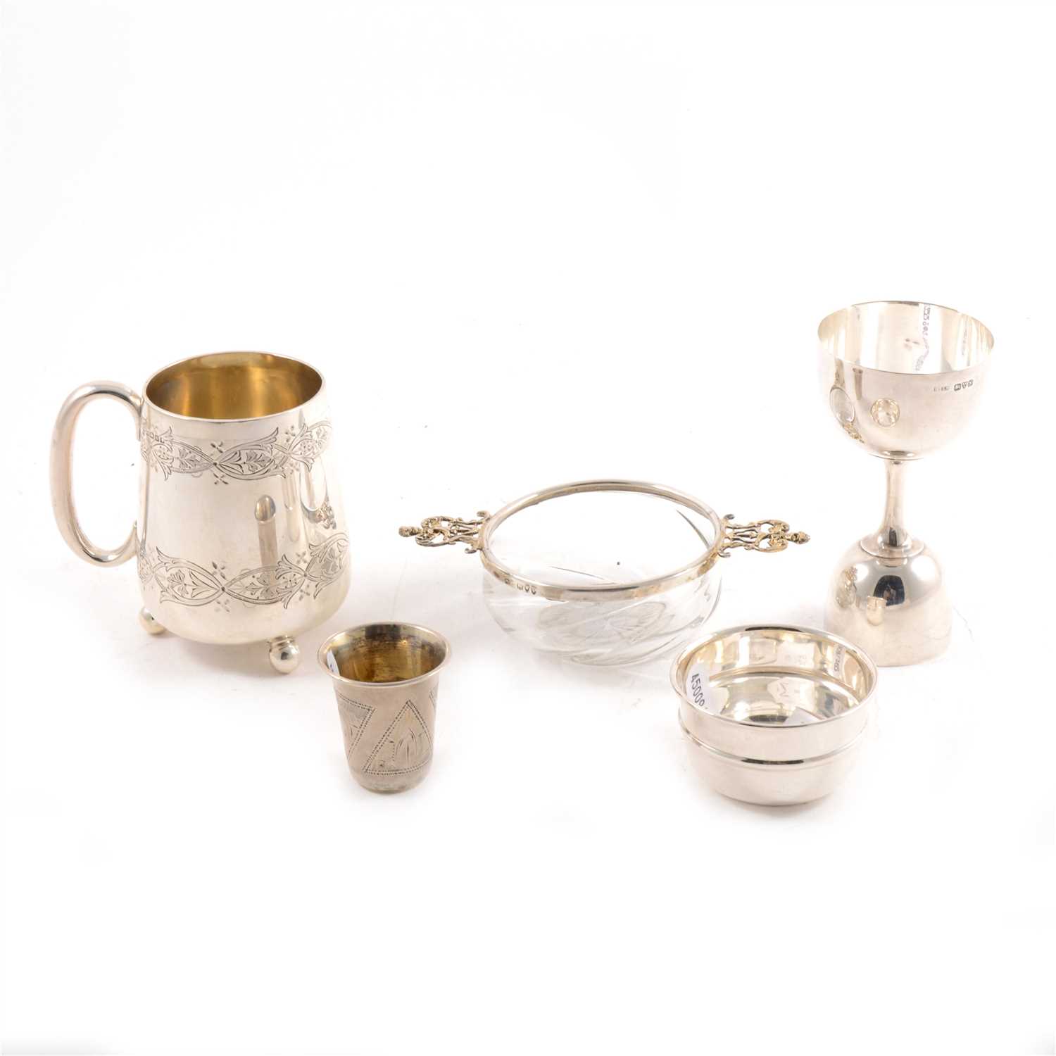 Lot 185 - A quantity of small silver, to include a christening mug, small cup, double jigger, Russian thimble and silver-mounted quaiche