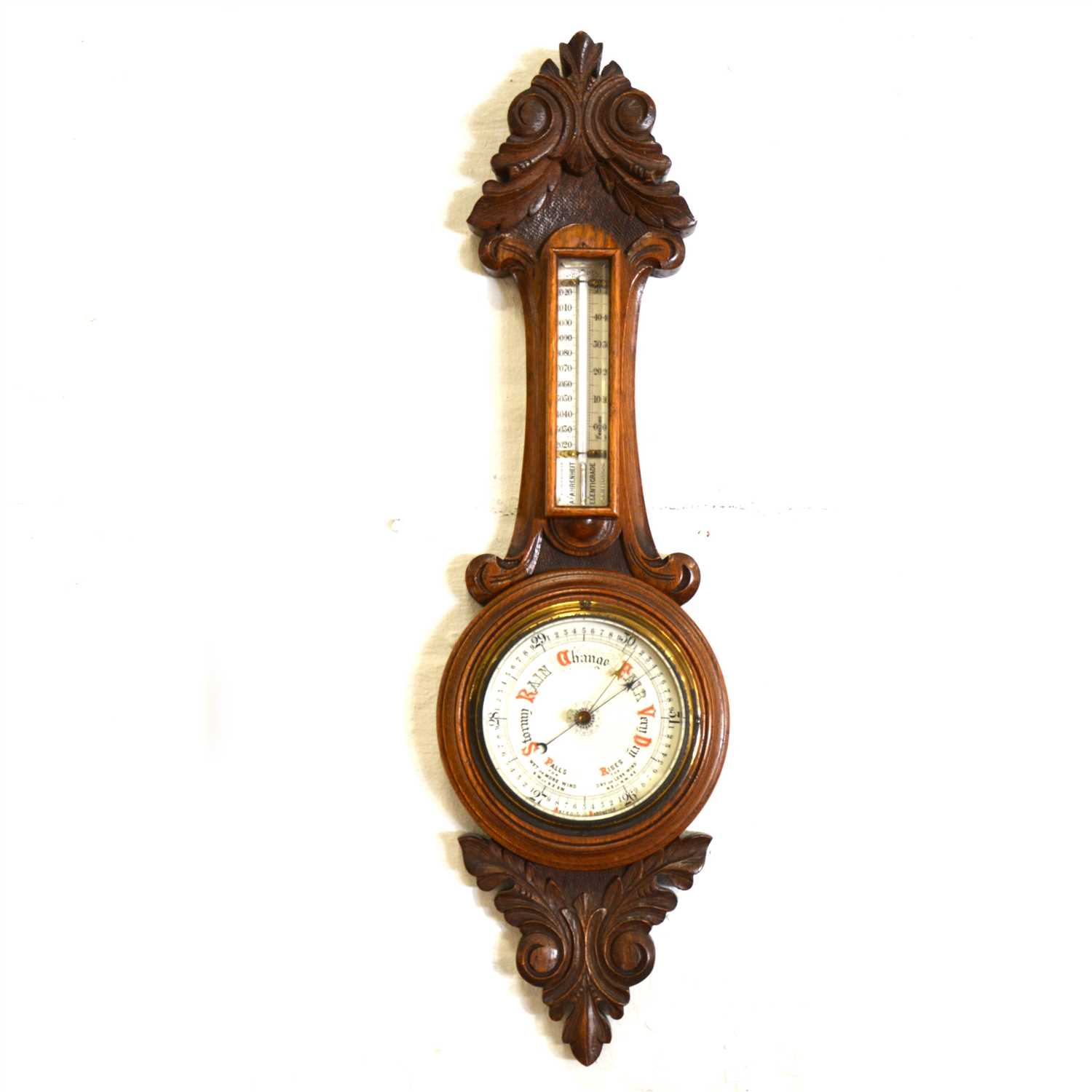 Lot 160 - An oak cased aneroid barometer with thermometer