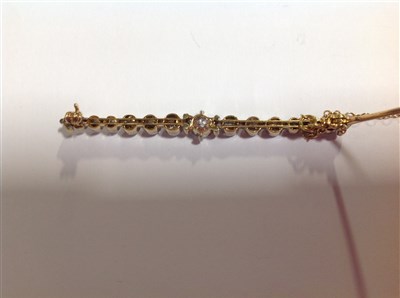 Lot 168 - A diamond set bar brooch.