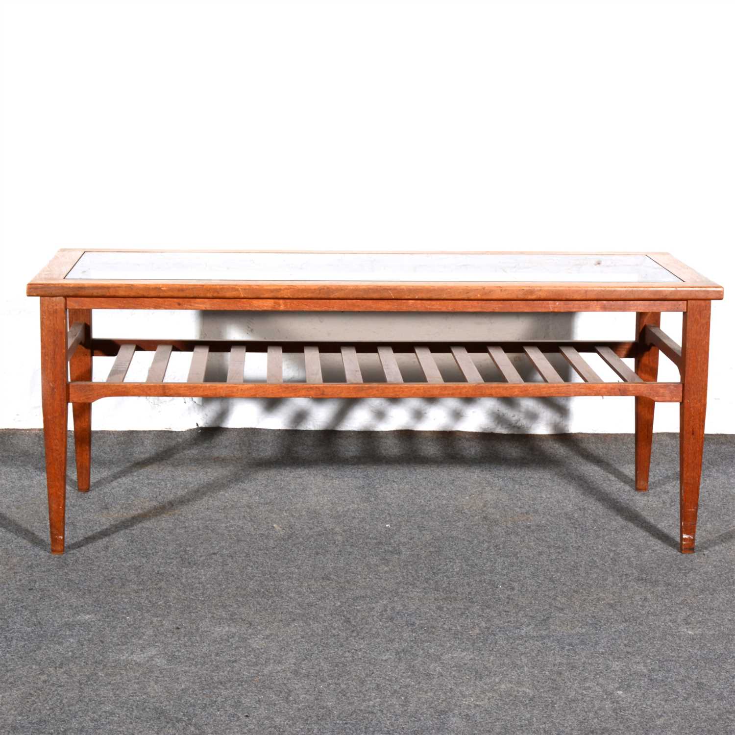 Lot 426 - A teak coffee table, smokey plate-glass top,...