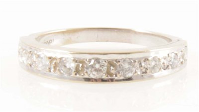 Lot 253 - A diamond half eternity ring.