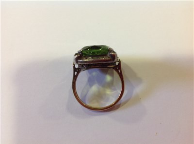 Lot 209 - A peridot and diamond cluster ring.