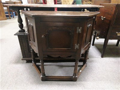 Lot 579 - A reproduction oak floor standing low level corner cabinet