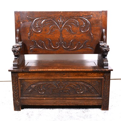 Lot 524 - Carved oak monks bench, folding top, box base,...