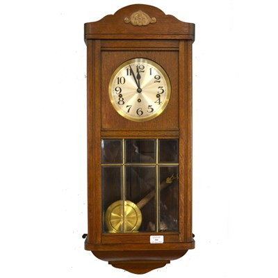 Lot 300 - An oak cased wall clock, striking on eight gongs