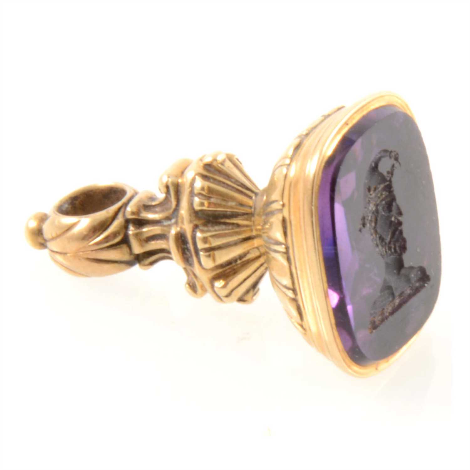 282 - A yellow metal seal with intaglio carved amethyst to base depicting a jester.